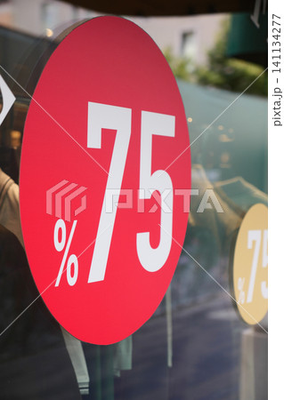 Store sign displays 75 percent discount offer to shoppers Store sign displays 75 percent discount offer to shoppers 141134277