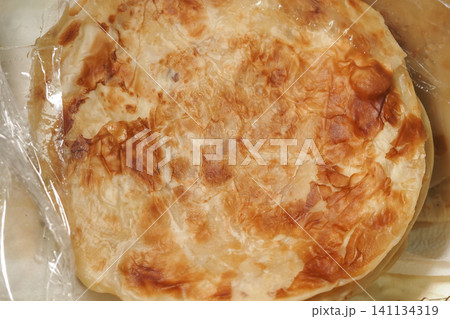 Delicious flatbread resting on a kitchen counter Delicious flatbread resting on a kitchen counter 141134319