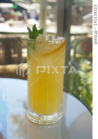 Refreshing drink is served in a tall glass at a cafe Refreshing drink is served in a tall glass at a cafe 141134323