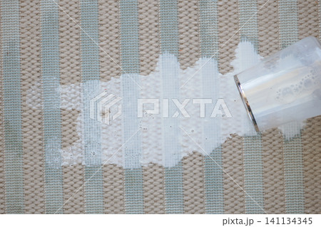 Spilled drink on a patterned carpet during the day Spilled drink on a patterned carpet during the day 141134345