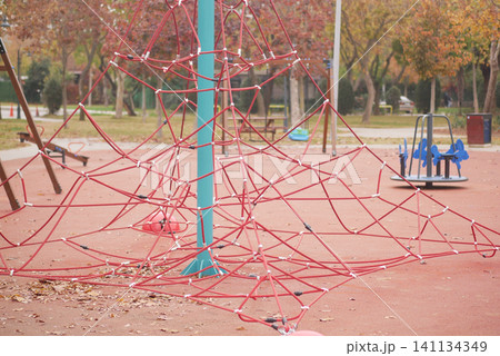 Playground climbing structure in a city park during autumn 141134349