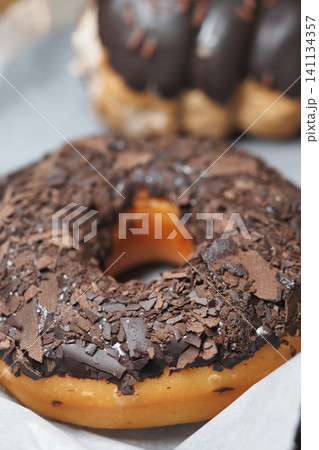 Delicious chocolate donut covered in chocolate shavings Delicious chocolate donut covered in chocolate shavings 141134357