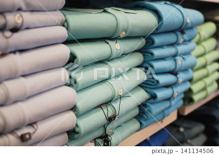 Shirts neatly folded and displayed in a retail store 141134506