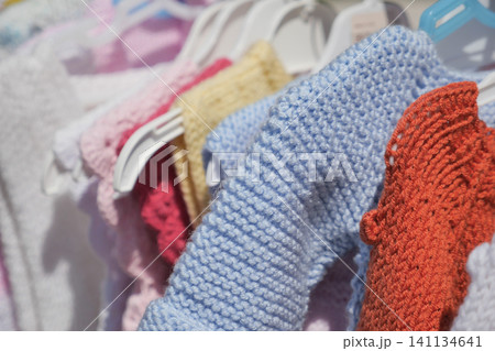 Colorful handmade textiles hang in a boutique 141134641