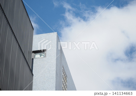 Modern architecture against a blue sky with clouds Modern architecture against a blue sky with clouds 141134663