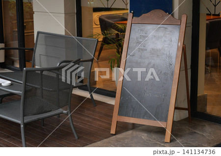 Outdoor seating area with chalkboard menu near cafe Outdoor seating area with chalkboard menu near cafe 141134736