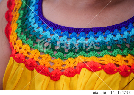 Child with Colorful crochet detail on traditional dress Child with Colorful crochet detail on traditional dress 141134798