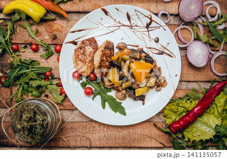 Tasty meat rolls with sour cream and salad on wooden table 141135057