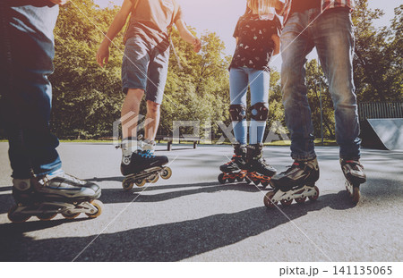 Legs wearing roller skating shoe. Outdoors. Skatepark 141135065