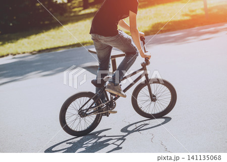 Bmx rider performing tricks at skatepark. Bmx rider performing tricks at skatepark. 141135068