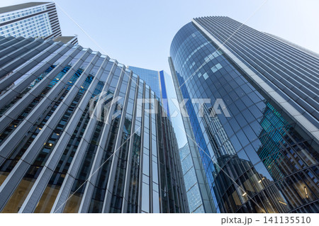 Reflective glass facade of high rise buildings in a city financial center Reflective glass facade of high rise buildings in a city financial center 141135510