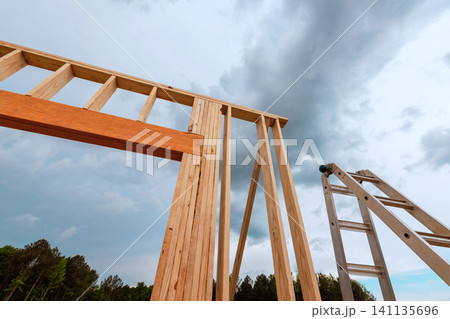Construction of wooden structure with tall ladder Construction of wooden structure with tall ladder 141135696