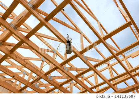 Construction workers build wooden structure timber framing wood beams building site Construction workers build wooden structure timber framing wood beams building site 141135697