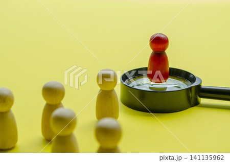 Wooden figure in red representing leading a team with focus in mind Wooden figure in red representing leading a team with focus in mind 141135962