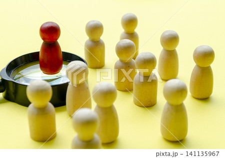 A red wooden figure representing a leader direction the followers with customizable space for text A red wooden figure representing a leader direction the followers with customizable space for text 141135967