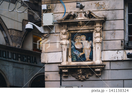Madonna shrine on the facade of the old house in Genoa, Italy 141138324