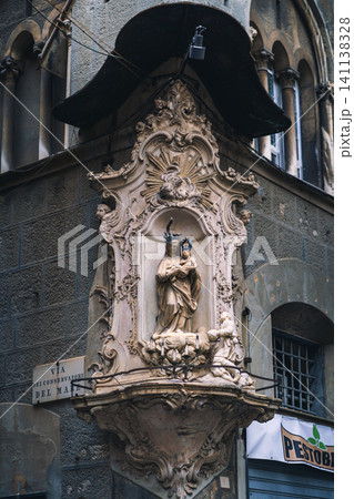 GENOA, ITALY - NOVEMBER 04, 2018 - Madonna shrine on the facade of the old house in Genoa 141138328