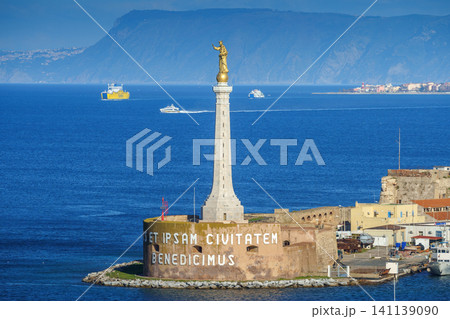 MESSINA, ITALY - NOVEMBER 06, 2018 - Forte del Santissimo Salvatore with statue of Saint Mary or Madonna Della Lettera with the ships and the sea MESSINA, ITALY - NOVEMBER 06, 2018 - Forte del Santissimo Salvatore with statue of Saint Mary or Madonna Della Lettera with the ships and the sea 141139090