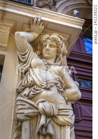 Marseille, France - Nov 03 2018, vertical close up view of the caryatid sculpture adorning the facade of one of the ancient buildings of Marseille, France Marseille, France - Nov 03 2018, vertical close up view of the caryatid sculpture adorning the facade of one of the ancient buildings of Marseille, France 141139221