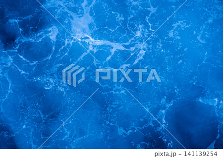 Rough deep turquoise and blue Mediterranean sea with white foam texture background Rough deep turquoise and blue Mediterranean sea with white foam texture background 141139254