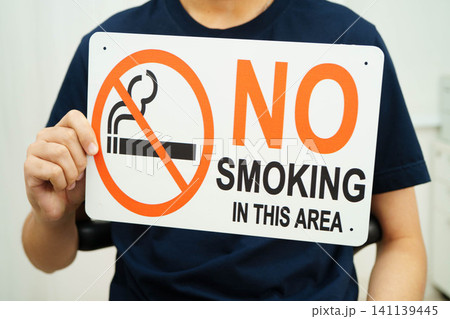 Male holding a no smoking sign. Male holding a no smoking sign. 141139445