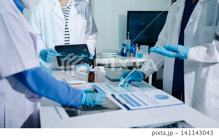Professional female doctor using futuristic AI digital interface for patient health monitoring and diagnostic analysis in laboratory Professional female doctor using futuristic AI digital interface for patient health monitoring and diagnostic analysis in laboratory 141143043