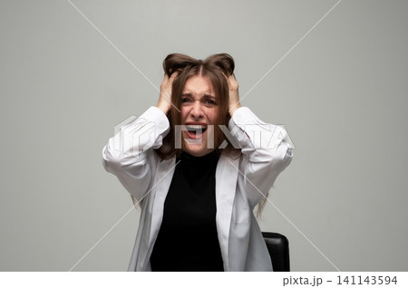 Woman experiencing extreme stress and burnout, screaming in agony, pulling hair due to overwhelming anxiety and frustration Woman experiencing extreme stress and burnout, screaming in agony, pulling hair due to overwhelming anxiety and frustration 141143594