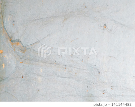 Abstract background of a weathered and distressed wall with peeling paint and plaster in faded light blue and beige tones, showcasing aged texture and grunge details. Abstract background of a weathered and distressed wall with peeling paint and plaster in faded light blue and beige tones, showcasing aged texture and grunge details. 141144482