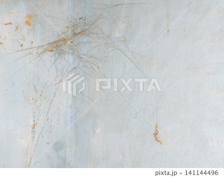 Abstract background of a weathered and distressed wall with peeling paint and plaster in faded light blue and beige tones, showcasing aged texture and grunge details. Abstract background of a weathered and distressed wall with peeling paint and plaster in faded light blue and beige tones, showcasing aged texture and grunge details. 141144496
