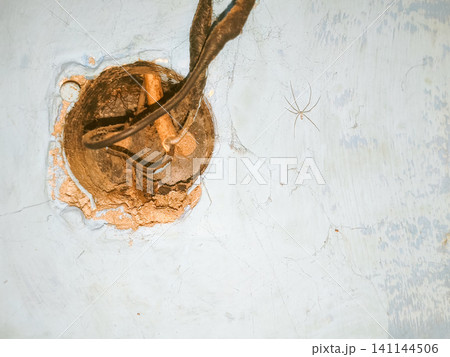 Abstract background of a weathered and distressed wall with peeling paint and plaster in faded light blue and beige tones, showcasing aged texture and grunge details. Abstract background of a weathered and distressed wall with peeling paint and plaster in faded light blue and beige tones, showcasing aged texture and grunge details. 141144506