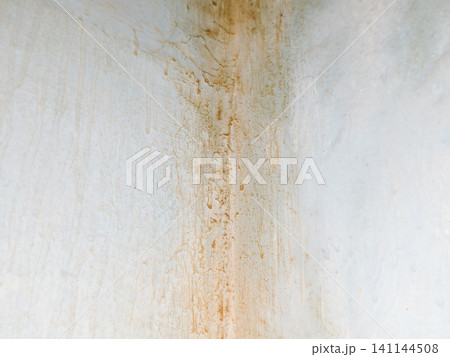 Abstract background of a weathered and distressed wall with peeling paint and plaster in faded light blue and beige tones, showcasing aged texture and grunge details. Abstract background of a weathered and distressed wall with peeling paint and plaster in faded light blue and beige tones, showcasing aged texture and grunge details. 141144508