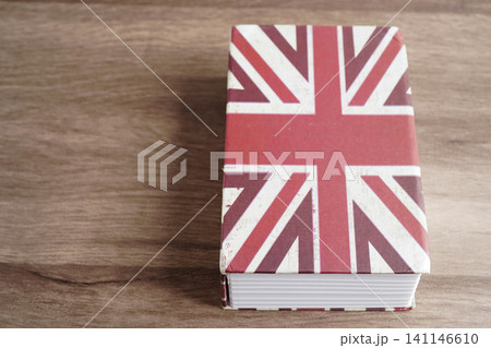 English book with graduate hat, learning and tutorial for foreigner. English book with graduate hat, learning and tutorial for foreigner. 141146610