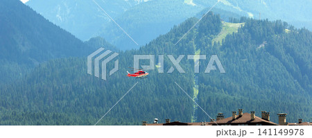 Bansko, Bulgaria, red emergency medical service helicopter flying over town, green Pirin mountains banner Bansko, Bulgaria, red emergency medical service helicopter flying over town, green Pirin mountains banner 141149978