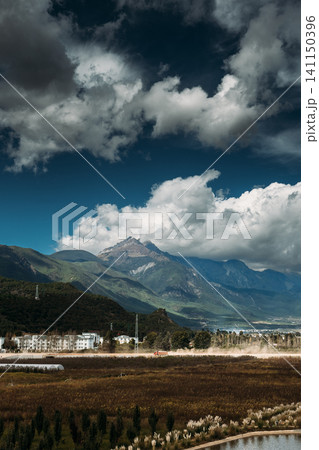 Yulong Snow Mountain peak above rural Lijiang fields Yulong Snow Mountain peak above rural Lijiang fields 141150396