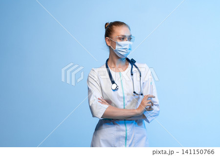 Confident young woman working as a professional doctor or nurse. Medical healthcare staff ready for vaccination or injection Confident young woman working as a professional doctor or nurse. Medical healthcare staff ready for vaccination or injection 141150766