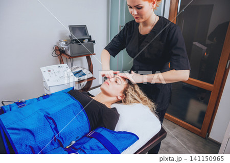 Pressotherapy machine on woman in beauty center Pressotherapy machine on woman in beauty center 141150965