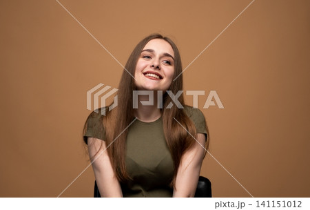 Young woman smiling, expressing happiness, fun, cheerfulness, and positive emotions in a studio portrait Young woman smiling, expressing happiness, fun, cheerfulness, and positive emotions in a studio portrait 141151012