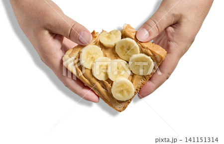 toast slice with peanut butter and banana in human hands 141151314