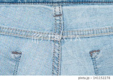 Closeup of light blue denim jeans with detailed stitching and texture Closeup of light blue denim jeans with detailed stitching and texture 141152278