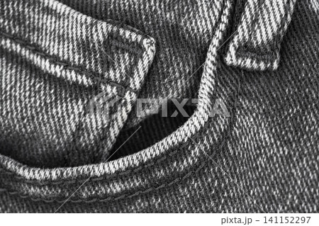 Denim fabric texture with pocket detail in monochrome flat lay 141152297