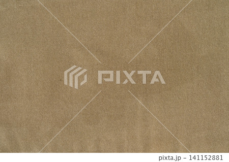 Close up of textured beige fabric with woven pattern 141152881