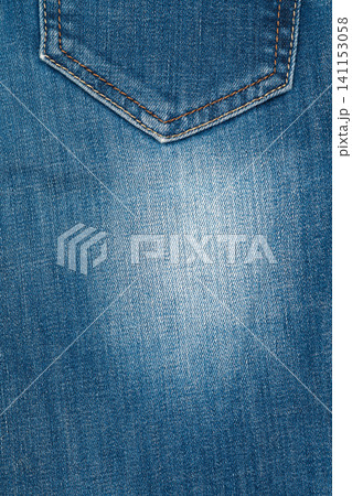 Blue jeans texture back pocket. Closeup cotton fabric with orange stitching. Background copy space Blue jeans texture back pocket. Closeup cotton fabric with orange stitching. Background copy space 141153058