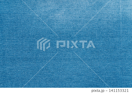 Blue denim fabric texture background. Closeup of classic jeans textile material 141153321