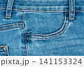 Blue denim jeans texture with front pocket and orange stitching detail 141153324