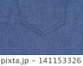 Blue denim fabric texture with seam detail. Close up of jeans material background 141153326
