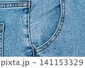 Blue denim jeans front pocket texture with orange stitching 141153329