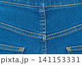 Blue denim jeans texture background with yellow stitching. Closeup jeans fabric showing seam detail 141153331