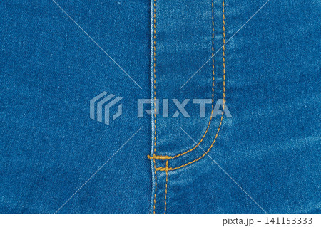 Classic blue denim background with golden thread seam on fly 141153333