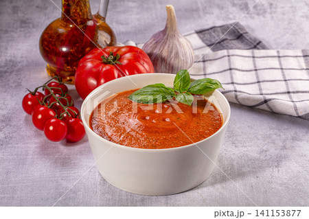 Fresh gazpacho soup in white bowl with tomatoes and basil Fresh gazpacho soup in white bowl with tomatoes and basil 141153877