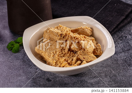 Traditional Halva Sweet Slices in white ceramic Bowl 141153884